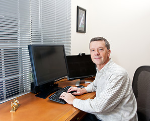 Image showing Senior man at computer desk