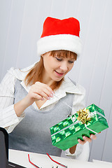 Image showing Girl in the office with a New Year gift