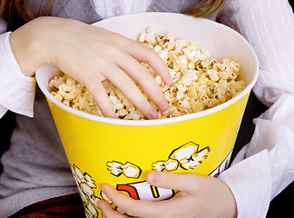 Image showing hand in a bucket of popcorn