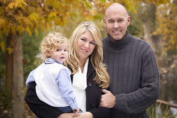 Image showing Young Attractive Parents and Child Portrait in Park