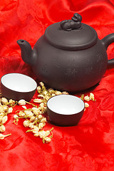 Image showing jasmine tea over red silk