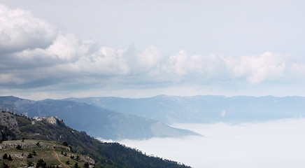 Image showing mountains between clouds
