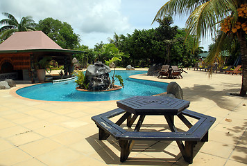 Image showing Table, poolo and palm trees