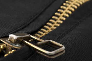 Image showing Closed yellow metal zipper
