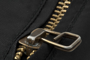 Image showing Closed yellow metal zipper