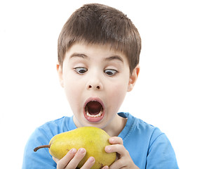 Image showing Child eating a pear