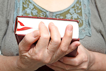 Image showing Human hands holding a book.