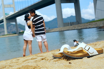 Image showing modern couple kissing each other on beach 