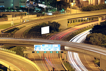 Image showing Freeway in night with cars light in modern city. 