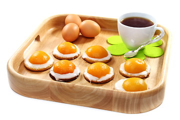 Image showing Easter biscuits and a cup of tea on wooden tray.