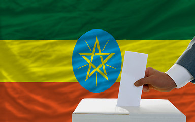 Image showing man voting on elections in ethiopia in front of flag