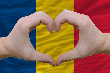 Image showing Heart and love gesture showed by hands over flag of romania back