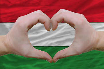 Image showing Heart and love gesture showed by hands over flag of hungary back