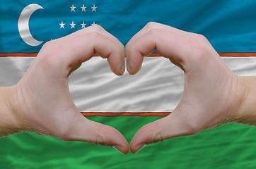 Image showing Heart and love gesture showed by hands over flag of uzbekistan b
