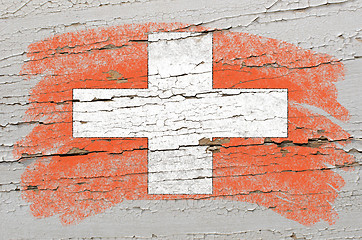 Image showing flag of schwitzerland on grunge wooden texture painted with chal