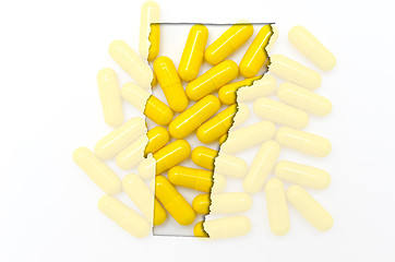 Image showing Outline map of vermont with transparent pills in the background