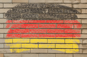 Image showing flag of Germany on grunge brick wall painted with chalk  