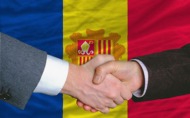 Image showing businessmen handshake after good deal in front of andora flag