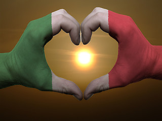 Image showing Heart and love gesture by hands colored in italy flag during bea