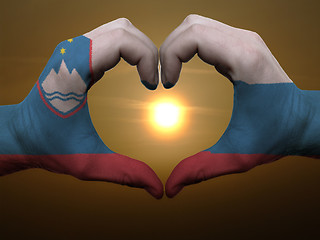 Image showing Heart and love gesture by hands colored in slovenia flag during 