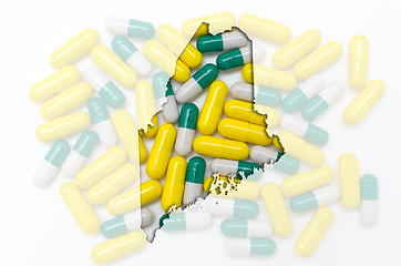 Image showing Outline map of maine with transparent pills in the background