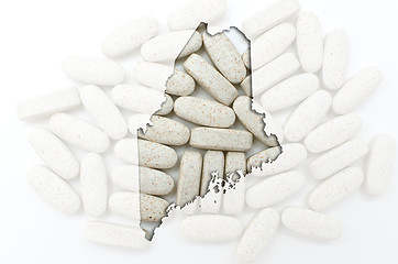 Image showing Outline map of maine with transparent pills in the background