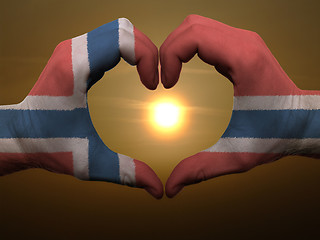 Image showing Heart and love gesture by hands colored in norway flag during be