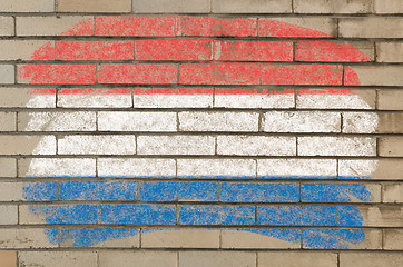 Image showing flag of Netherlands on grunge brick wall painted with chalk  