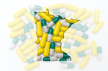 Image showing Outline map of minnesota with transparent pills in the backgroun