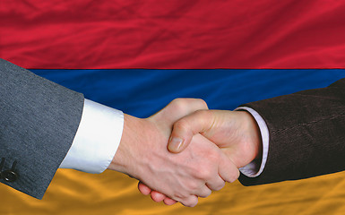 Image showing businessmen handshake after good deal in front of armenia flag