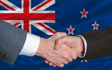 Image showing businessmen handshake after good deal in front of new zealand fl