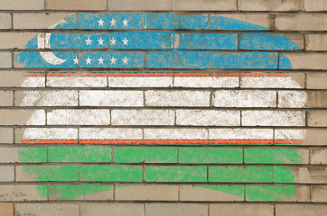 Image showing flag of uzbekistan on grunge brick wall painted with chalk  