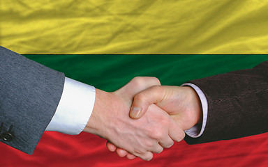 Image showing businessmen handshake after good deal in front of lithuania flag