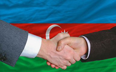 Image showing businessmen handshake after good deal in front of azerbaijan fla