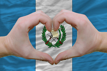 Image showing Heart and love gesture showed by hands over flag of guatemala ba