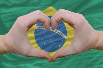 Image showing Heart and love gesture showed by hands over flag of Brazil backg