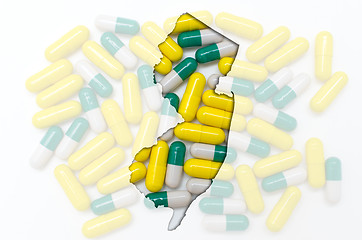 Image showing Outline map of new jersey with transparent pills in the backgrou