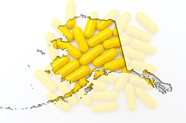 Image showing Outline Alaska map of with transparent pills in the background