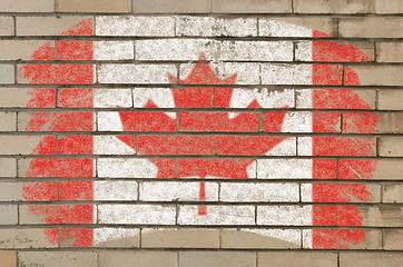 Image showing flag of Canada on grunge brick wall painted with chalk  