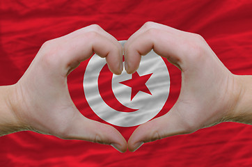 Image showing Heart and love gesture showed by hands over flag of tunisia back