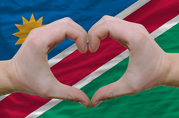 Image showing Heart and love gesture showed by hands over flag of namibia back