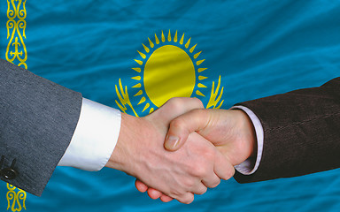 Image showing businessmen handshake after good deal in front of kazakhstan fla