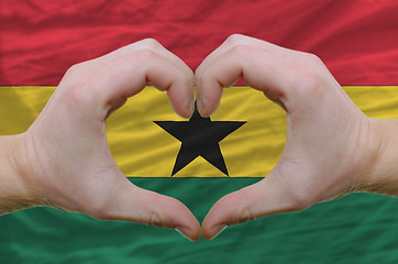 Image showing Heart and love gesture showed by hands over flag of ghana backgr