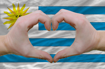 Image showing Heart and love gesture showed by hands over flag of uruguay back