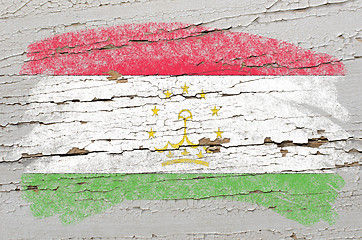 Image showing flag of tajikistan on grunge wooden texture painted with chalk  