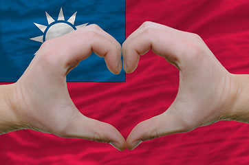 Image showing Heart and love gesture showed by hands over flag of taiwan backg