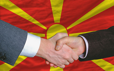 Image showing businessmen handshake after good deal in front of macedonia flag