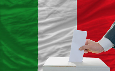 Image showing man voting on elections in italy in front of flag