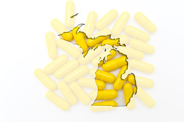 Image showing Outline map of michigan with transparent pills in the background