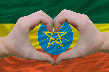 Image showing Heart and love gesture showed by hands over flag of ethiopia bac